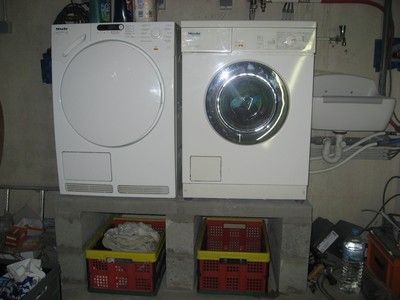 Een wasmachine en droger geplaatst in de kelder